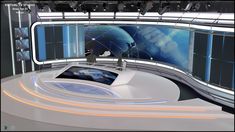 an empty television studio set with two monitors