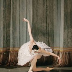 a ballerina in white tutu dancing on stage