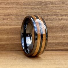 a wooden ring with blue and white inlays