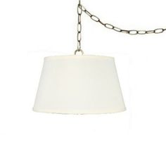 a white lamp hanging from a chain with a light shade on the top and bottom