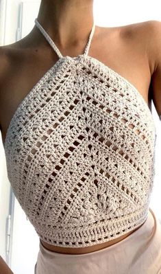 a woman wearing a crocheted halter top