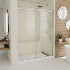 a bathroom with a walk in shower next to a bathtub and mirror on the wall