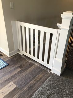 there is a dog laying on the floor next to a stair railing and rugs