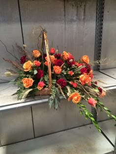 a basket filled with lots of flowers sitting on top of a counter next to a wall