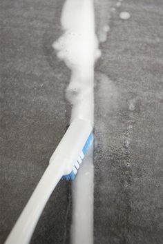 a toothbrush sitting on top of a sidewalk