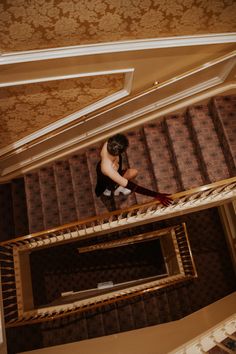 a man climbing up the stairs in a building