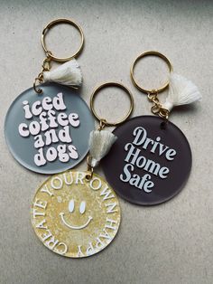 three key chains with different designs on them