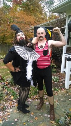 two people dressed in costumes posing for the camera