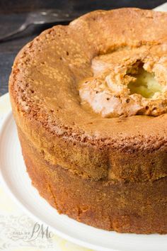 a round cake on a white plate with a yellow flowered napkin next to it