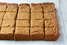 sliced up brownies sitting on top of a white paper towel next to each other