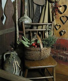 a wooden chair sitting next to a basket filled with vegetables