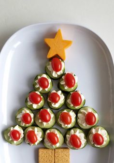 a christmas tree made out of crackers on a plate