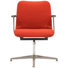 an orange office chair sitting on top of a metal base