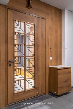 an open wooden door with glass panels on it