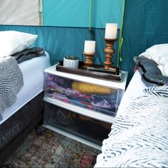 two beds in a tent with pillows and blankets