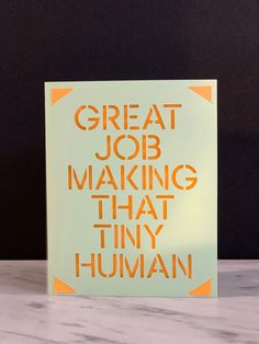 a greeting card with the words great job making that tiny human on it's front