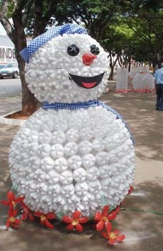 a snowman made out of balloons sitting on the ground