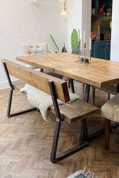 a wooden table with two benches in front of it on top of a hard wood floor