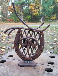 a sculpture made out of metal with horns on it