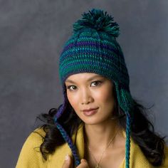 a woman wearing a green and blue hat