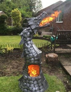 a fire breathing dragon statue in the yard