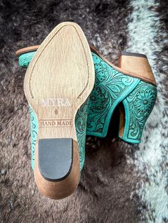 Step into the epitome of Southwestern flair with these Western leather booties, meticulously hand-tooled to highlight a stunning blend of rich deep teal and ebony. Featuring classic cowboy heels and convenient side slits, they blend traditional craftsmanship with modern ease. The intricate design, showcasing a pattern of desert blossoms, adds a distinctive touch of elegance. Ideal for transforming any ensemble, these tooled boots exude statement-making style with every step. 2-2.5" slanted heel. Tooled Boots, Cowboy Heels, Hay Bag, Classic Cowboy, Wrap Boots, Belted Sweater, Silver Jewelry Box, Spur Straps, Horse Boots