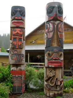 two totems are standing in front of a building