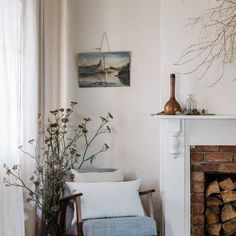 a living room filled with furniture and a fire place in front of a painting on the wall