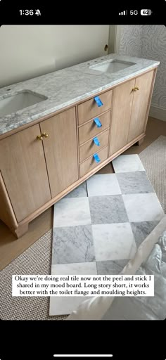 a bathroom vanity with two sinks and blue tape on the counter top that is taped together