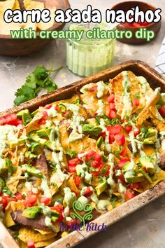 Carne asada nachos on sheet pan with text overlay that says 'carne asada nachos with creamy cilantro dip'. Carne Asada Nachos, Asada Nachos, Hearty Appetizer, Cilantro Dip, Baked Dips, Mexican Appetizers, Global Food, Summer Meal, Cheese Snacks