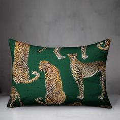 a green pillow with cheetah and leopards on it