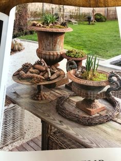 an open book with pictures of pots and plants on it's table in the garden