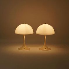 two lamps sitting next to each other on a table