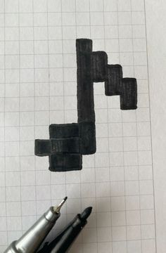 a piece of paper that has some sort of black object on it, next to a pen