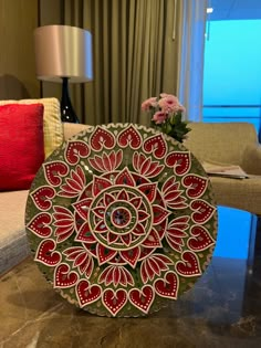 a decorative plate sitting on top of a table in a living room next to a couch