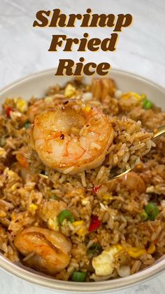 shrimp fried rice in a white bowl with a spoon on top and the words shrimp fried rice above it