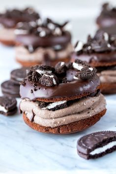 cookies and oreo cookies are stacked on top of each other with chocolate frosting