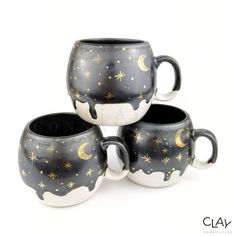 three black and white mugs with gold stars on them