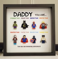 a shadow frame with legos in it that says, daddy you are and other superhero characters