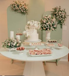 a table with flowers and desserts on it