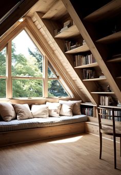 a window seat in the corner of a room with bookshelves and shelves on either side