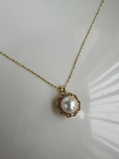 Add a touch of timeless elegance to your collection with our Vintage Lace Sunflower Freshwater Pearl Pendant. This exquisite piece features a beautifully crafted sunflower design, delicately intertwined with vintage lace patterns, and centered around a lustrous freshwater pearl. The intricate details and classic aesthetics make this pendant a perfect blend of vintage charm and modern sophistication. Pearl type: Freshwater pearl Pearl size: 11.5-12mm Colour: White Length: 45cm Findings: 18K gold Elegant Flower Filigree Necklace, Elegant Round Jewelry With Sunflower Design, Elegant Round Sunflower Jewelry, Elegant Round Sunflower Design Jewelry, Elegant Lace Necklaces As Gifts, Elegant Round Sunflower Design Necklace, Elegant Sunflower Design Flower Necklace, Vintage Pearl Necklace, Pearl Necklace Vintage