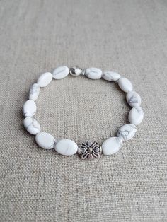 "READY TO SHIP. White Howlite Beaded Bracelet*Beaded Bracelets for Women*Bead Bracelet Women*Gemstone bracelet*White*Gift for her*Stretch bracelet for women. Beautiful natural White Howlite gemstone bracelet will make you look gorgeous. Howlite bracelet is the perfect addition to women's or girl's jewelry. Material: Natural Howlite gemstone, stretch cord, silver plated metal beads Color: White  Bracelet size: Approx. 17.15 cm / 6.75\" in (The size could be adjusted upon request) Beads size: Approx. 8x12 mm / 0.31\" x 0.47\" in Please note that color might slightly differ to photography.  For more natural gemstone bracelets, visit my shop: https://www.etsy.com/shop/LemonBracelet Thank you for shopping at LemonBracelet!" Cheap Everyday White Beaded Bracelets, Elegant Adjustable Howlite Jewelry, Howlite Bracelets With Round Beads As Gift, Natural Stone Bracelets For Gifts, Adjustable White Bracelet With Natural Stones, Adjustable White Crystal Bracelet With Gemstone Beads, Adjustable White Crystal Bracelet With Natural Stones, White Gemstone Beads Bracelet As Gift, White Beaded Crystal Bracelet For Healing