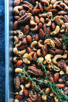 nuts and rosemary sprigs in a baking dish