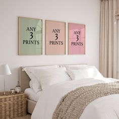 a bedroom with three prints hanging on the wall above the bed, and a wicker basket next to it