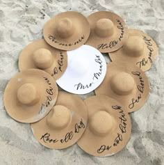 six hats are arranged in a circle with the names of five people on them, and one is signed