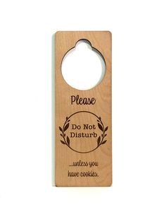 a wooden door hanger with the words please do not disturb unless you have cookies