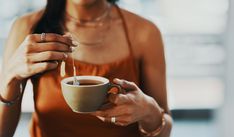 a woman holding a cup of coffee in her hands