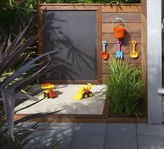 an outdoor play area with toys and sand