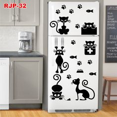 the refrigerator is decorated with cats and fish decals